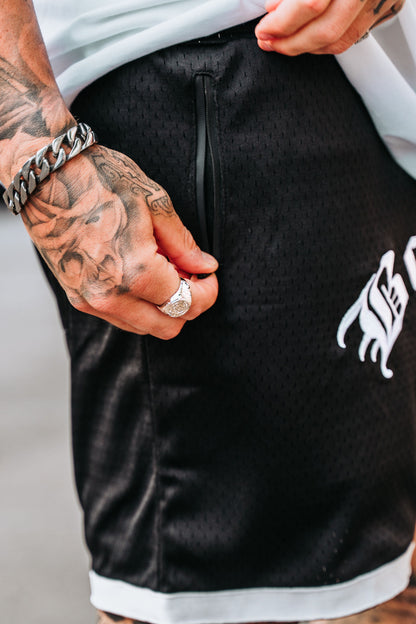 Meshed shorts, male model with tattoos and jewellry