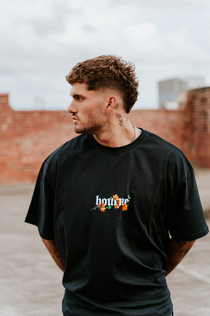 male model in urban setting wearing a flower streetwear t-shirt