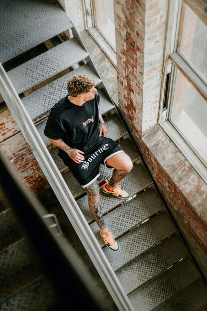 male model sitting in a stairwell