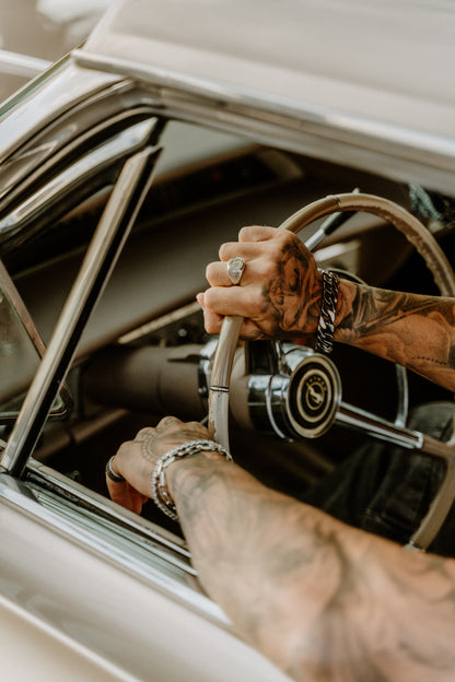 hands on a steering wheel, tattoos, jewellry