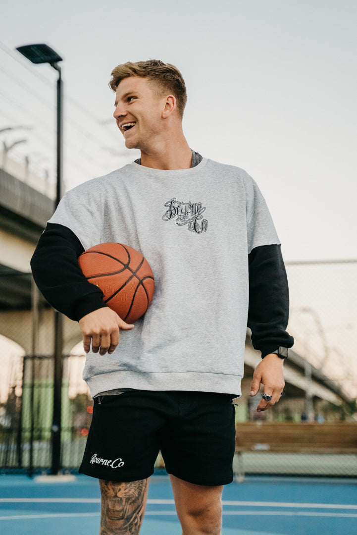 male model, holding a basketball, on a basketball court, laughing