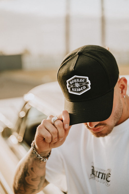 male model looking down to show off a hat