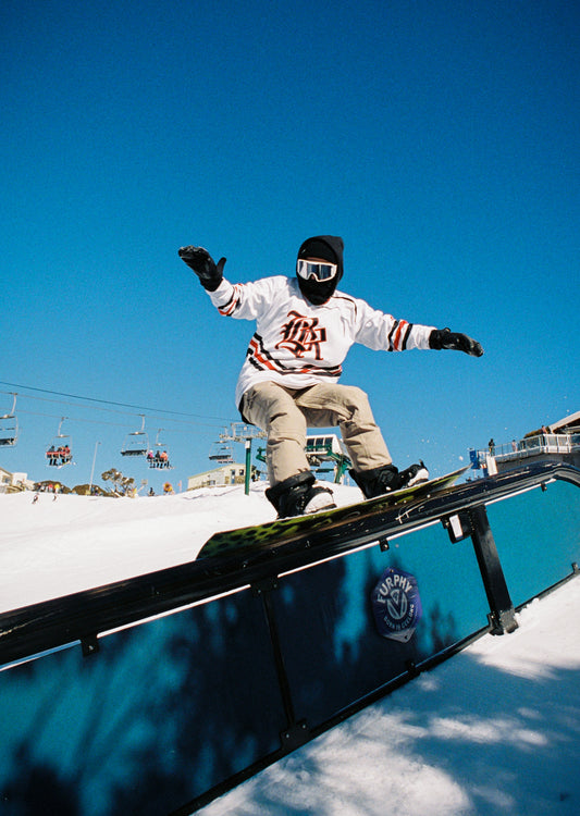 snowboarder grinding a rail