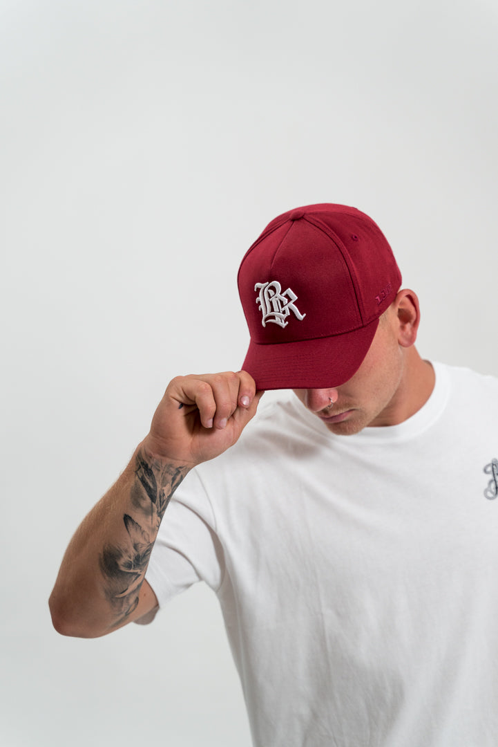 male model wearing red hat and white t-shirt, white background