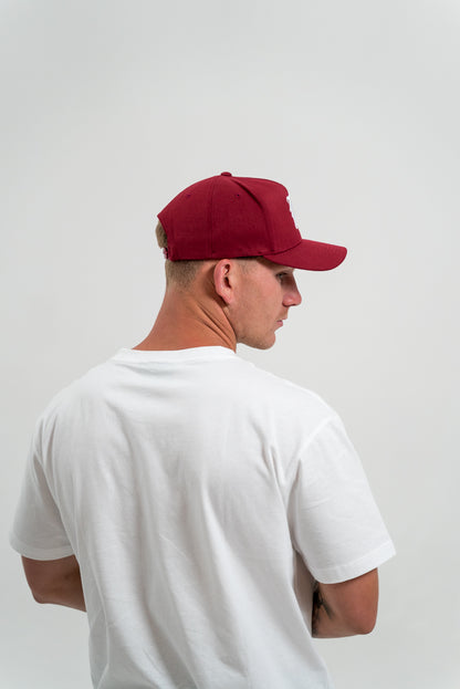 male model wearing red hat and white t-shirt, white background